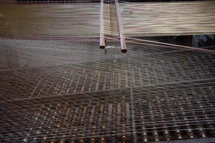 A loom and its silk threads in Luigi Bevilacqua Factory