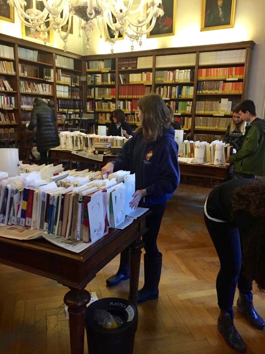 Young students at the Querini Stampalia library in Venice take care of the damaged books after the floods